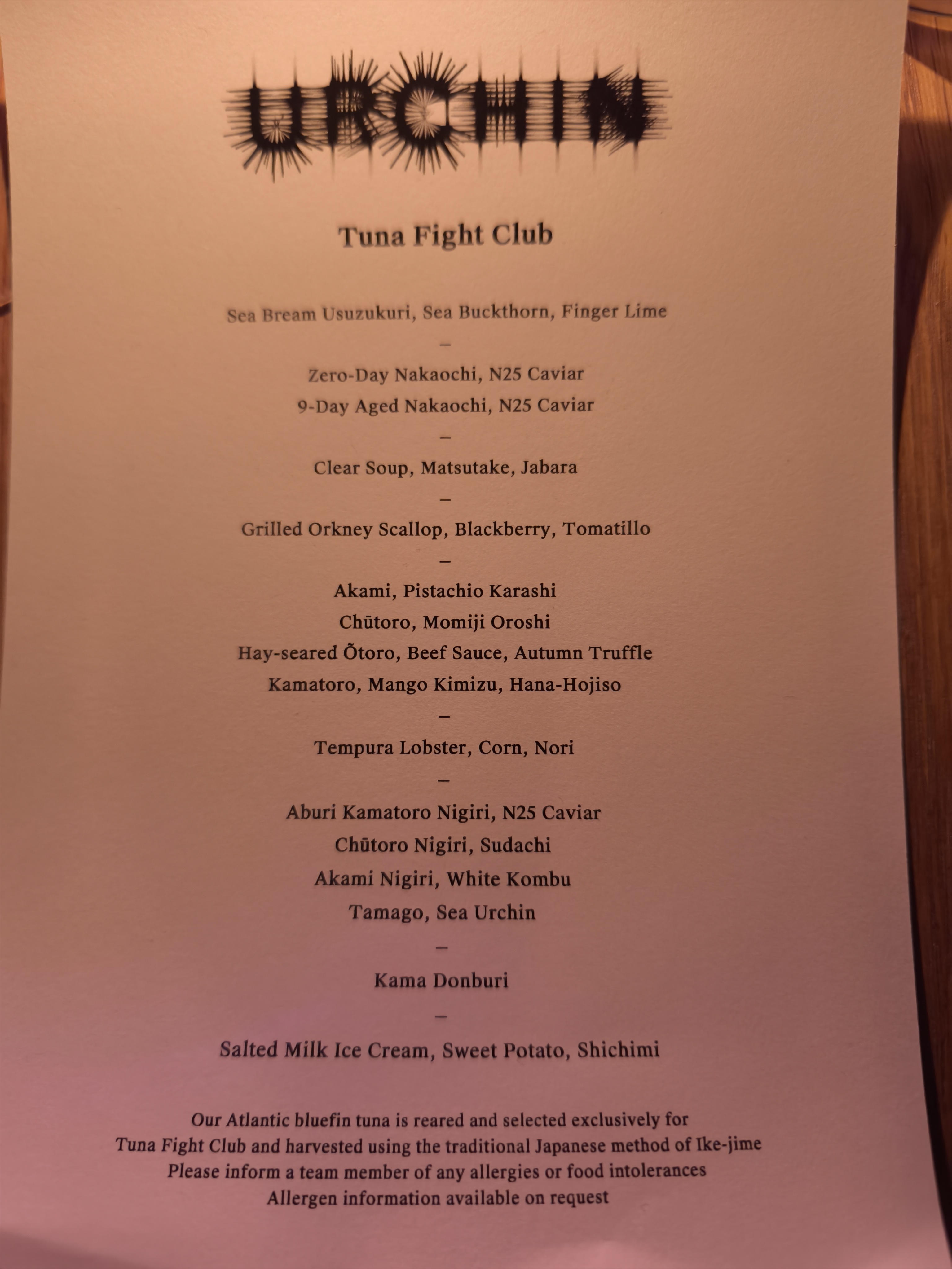 A close-up view of the Urchin Tuna Fight Club menu listing all the courses and their key ingredients.